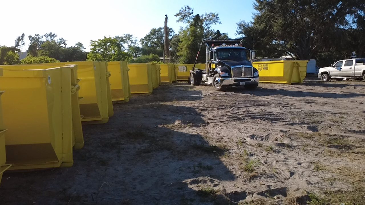 Haul Hogs dumpsters and truck on a Tampa job